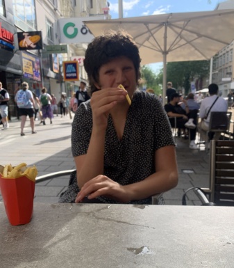 Ein Mädchen sitzt an einem Tisch und isst ein Eis